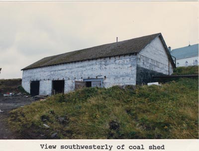Photo of the southwesterly view of the coal shed, a white  building.